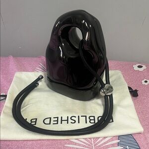 Published by chrome cross body bag!Glossy Black Sculptural Handbag